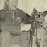 T-Sgt. Harold E. Rogers, with his flying mascot Minster