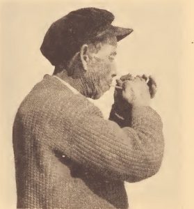Pamunkey hunter demonstrating method of calling wild turkey with a wing-bone call